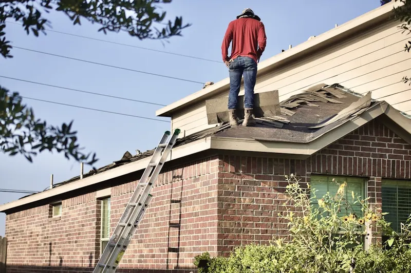 Professional roofer working on a residential roof in Middle East